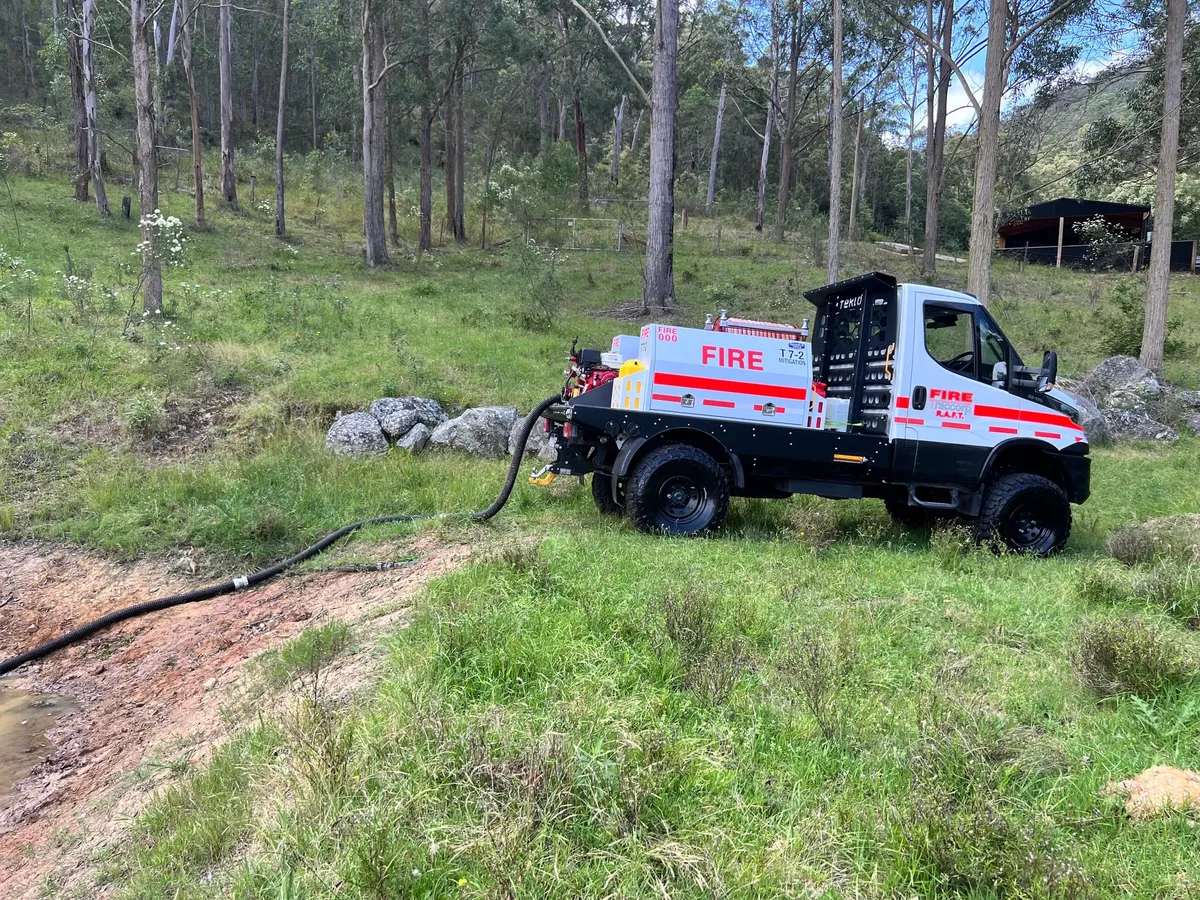 4x4 tanker drafting from a water source on a bush slope