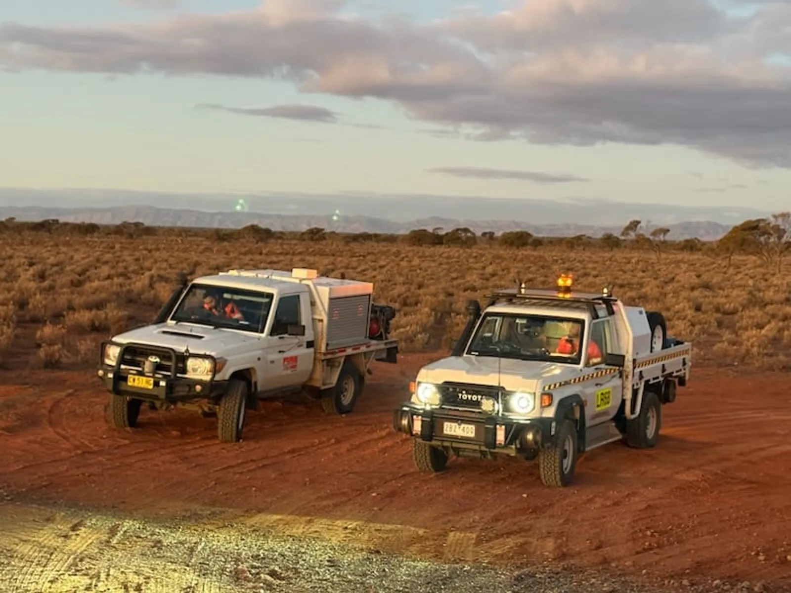 Traccorp response vehicles on a remote track at dusk