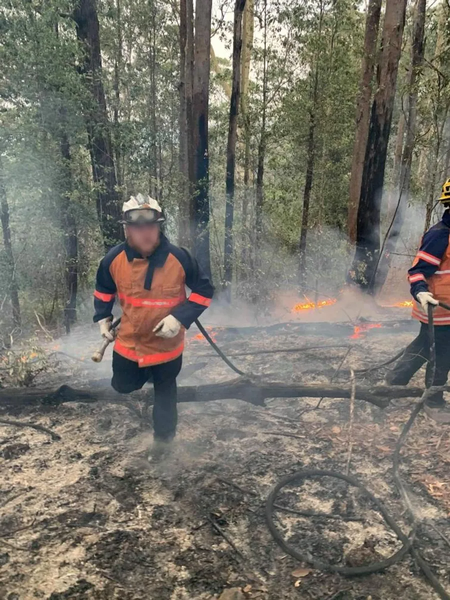 Traccorp firefighter at the edge of a prescribed burn