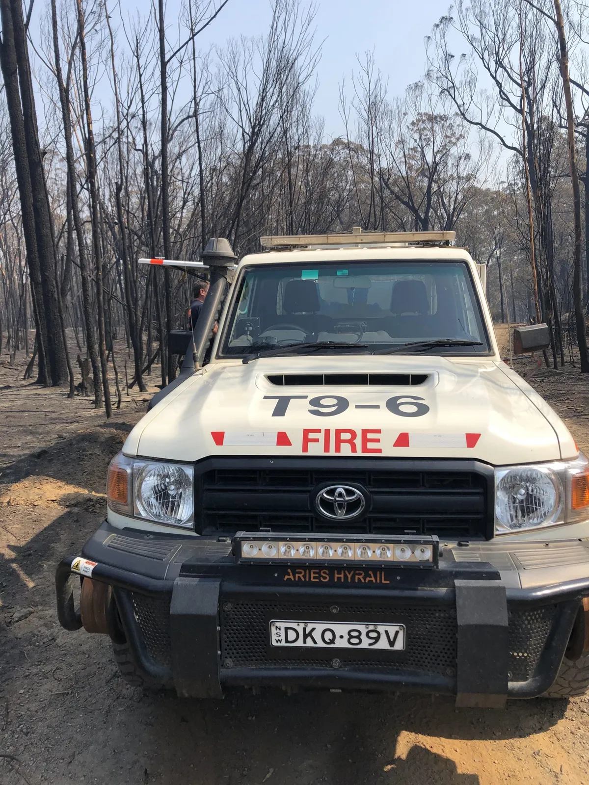 Traccorp firefighter beside a fire appliance