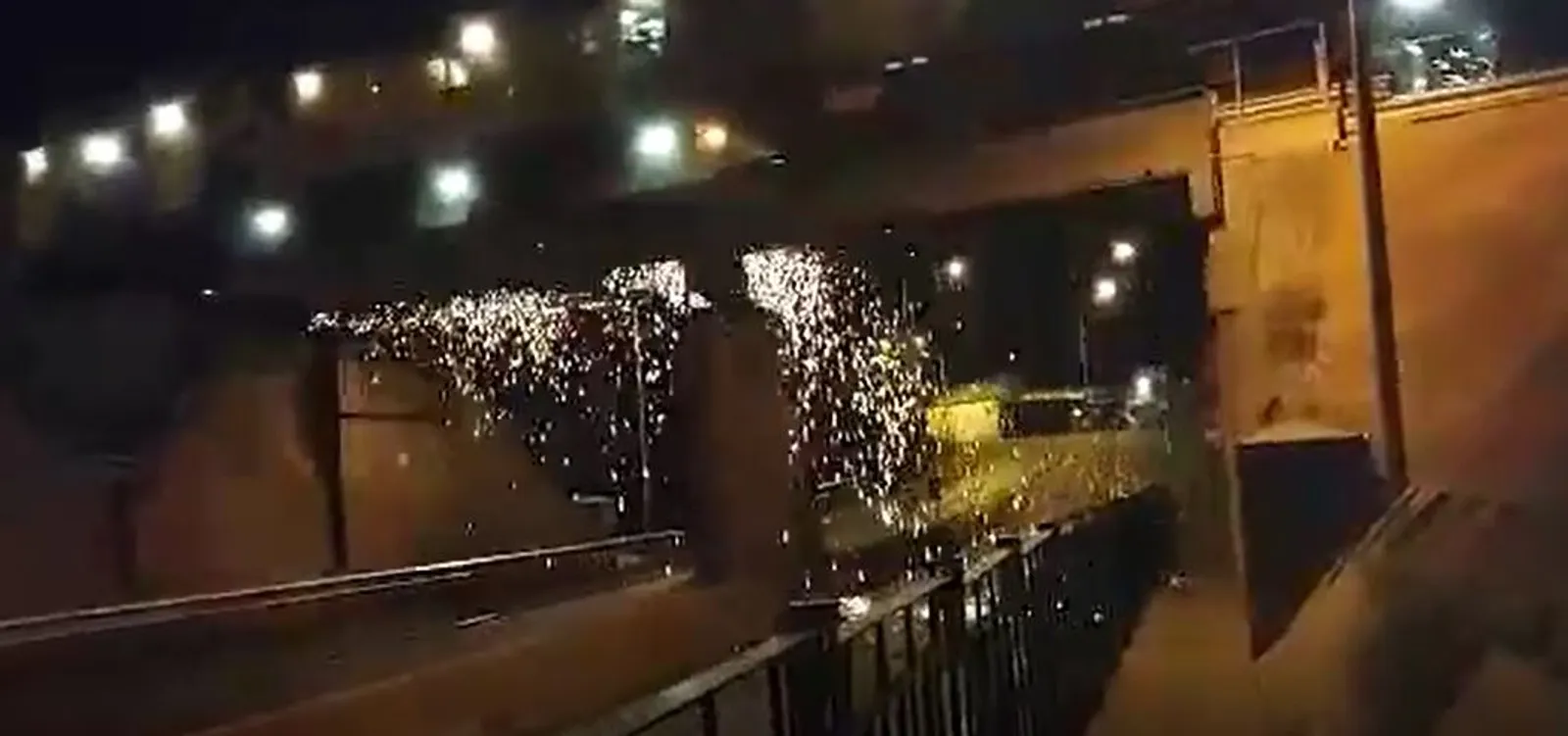 Sparks flying from a track grinding train at night