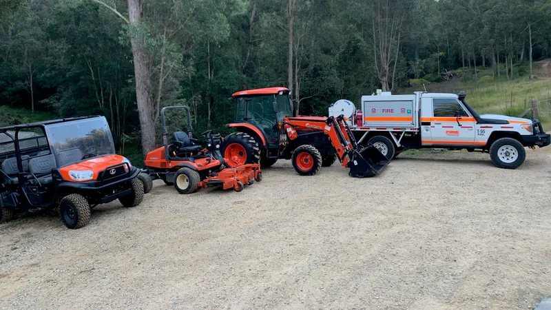 Fire-response buggy, mower, tractor and slasher, and a Striker lined up
